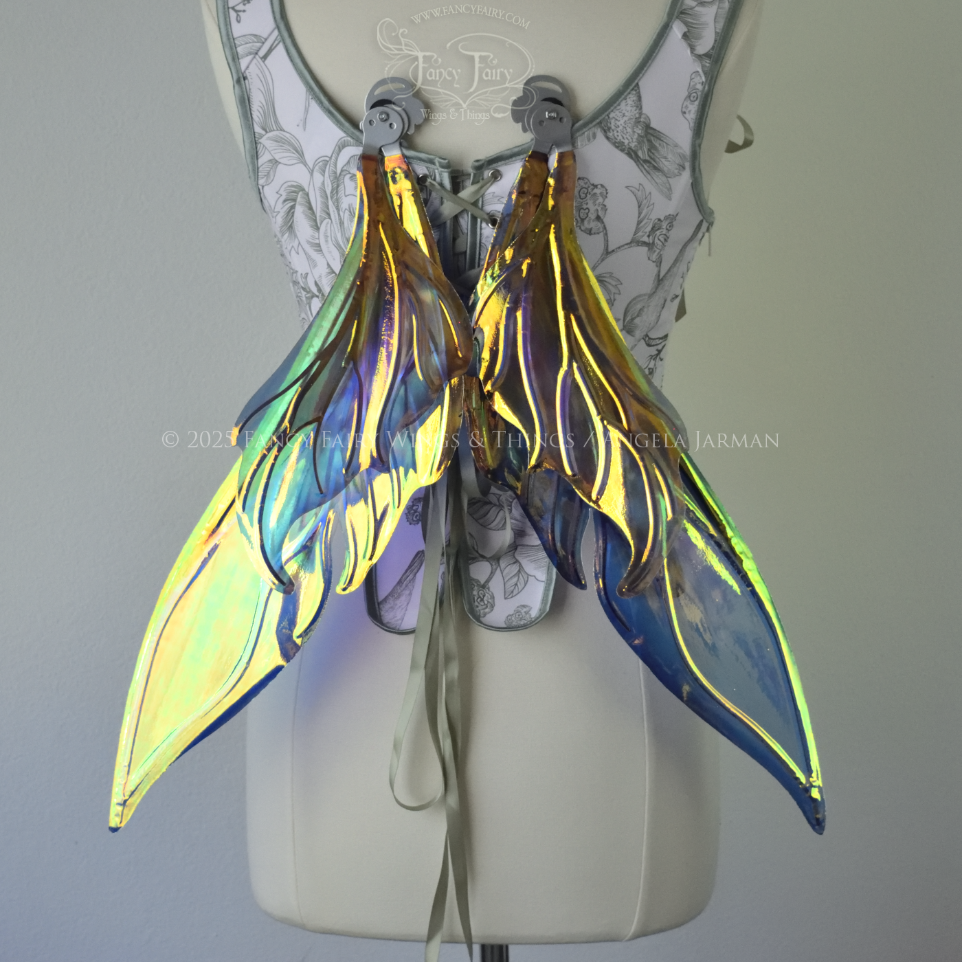 Iridescent elongated teal fairy wings with touches of purple and silver veins, back view, in resting position