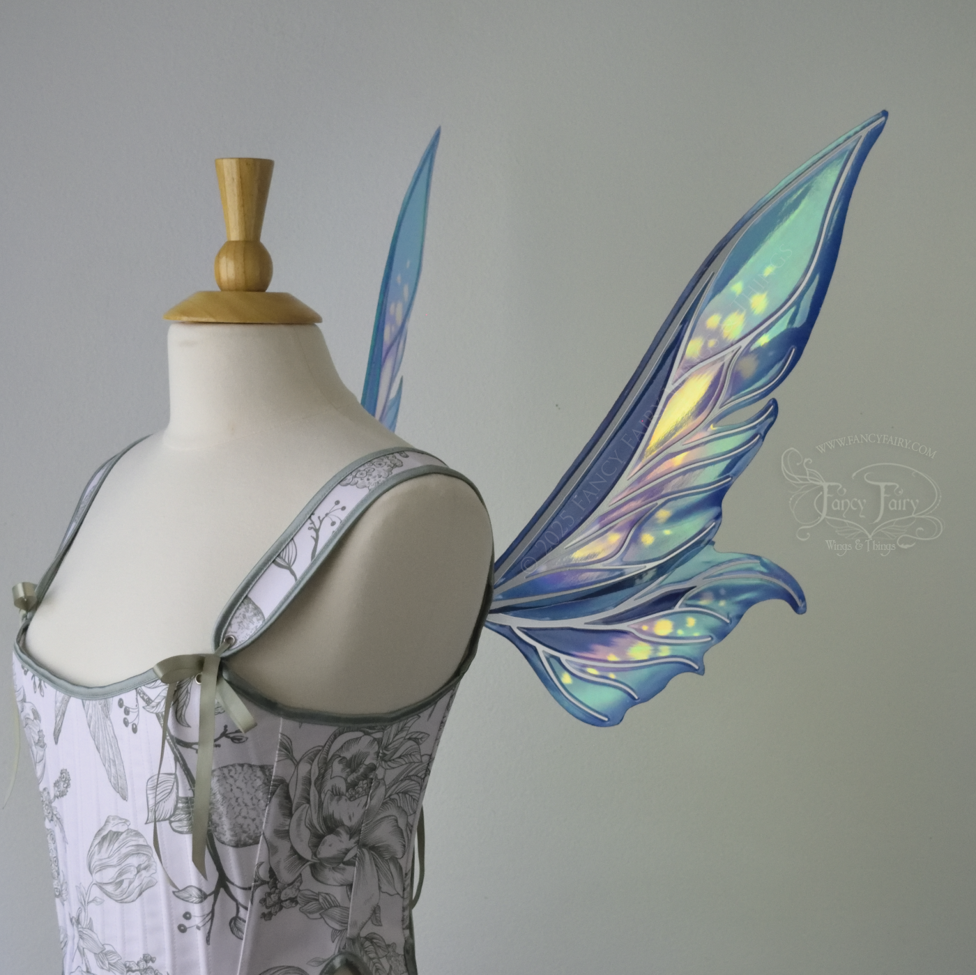 Iridescent elongated teal fairy wings with touches of purple and silver veins, right side view 