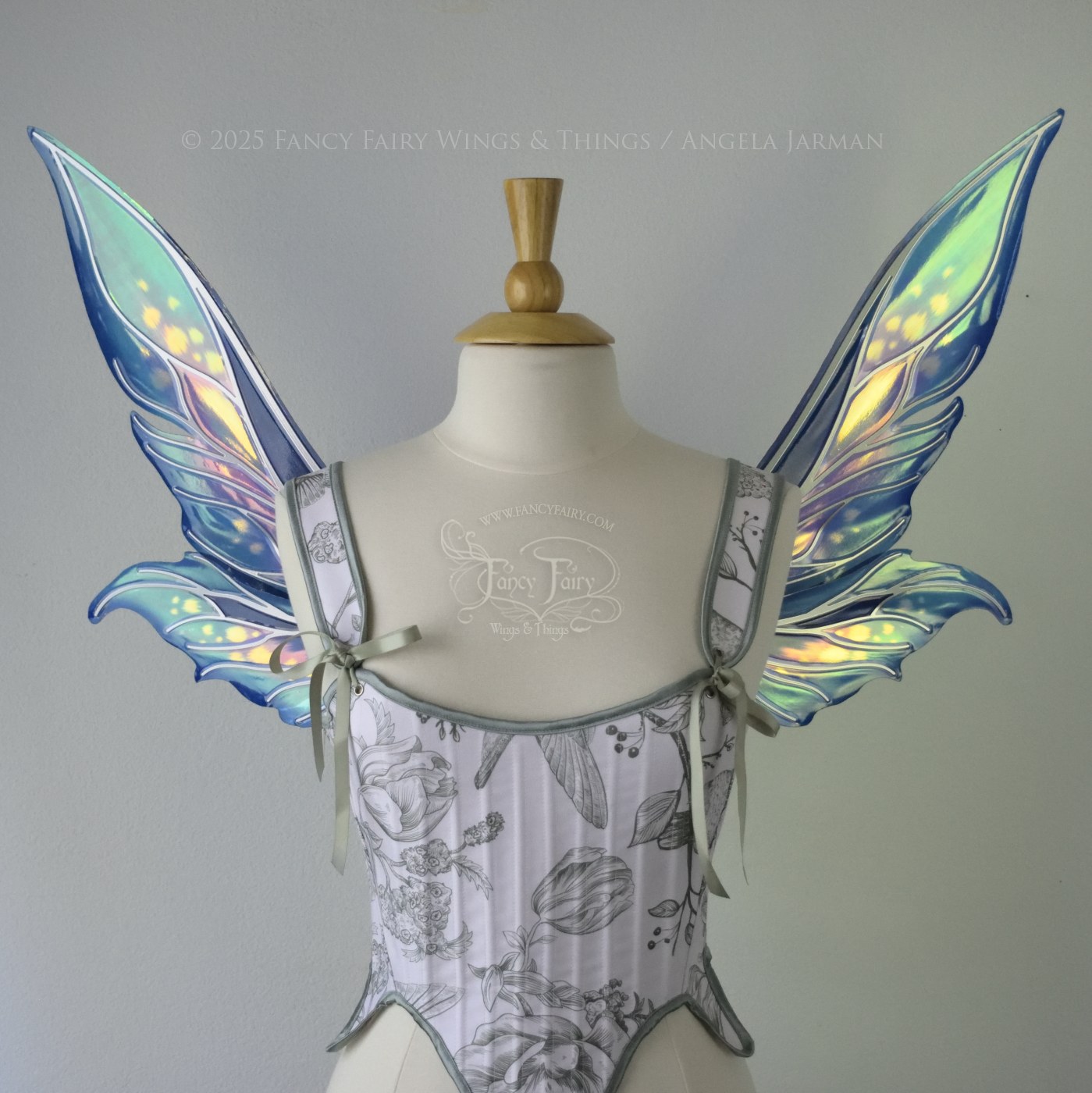 Iridescent elongated teal fairy wings with touches of purple and silver veins, front view