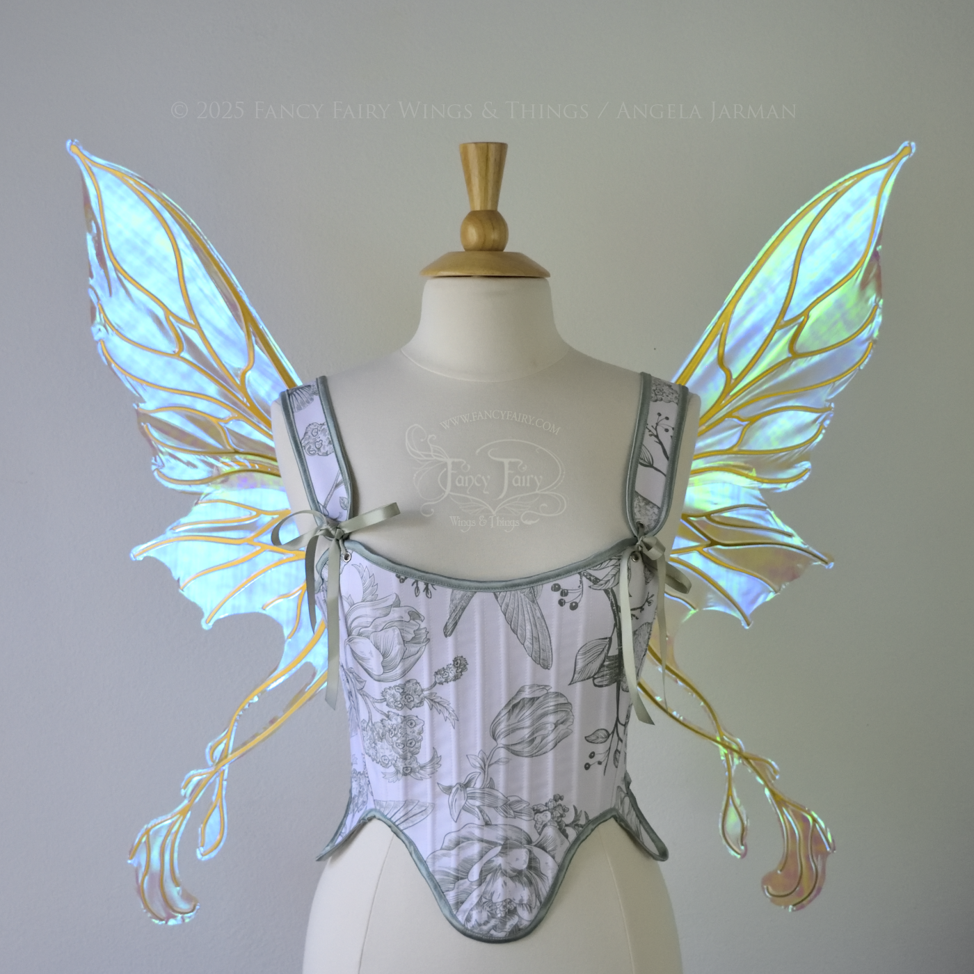 Transparent blue / green iridescent fairy wings with pointed upper tips and 2 swirling tails on the bottom panels with gold veins, worn on a dress form, front view