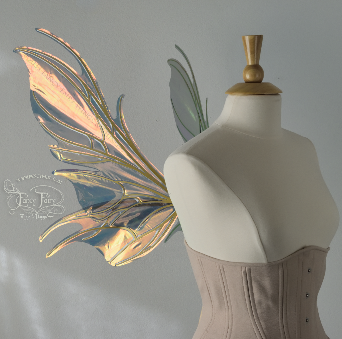 Left side view of iridescent orange & dark grey/blue fairy wings with spikey veins, worn by a dress form