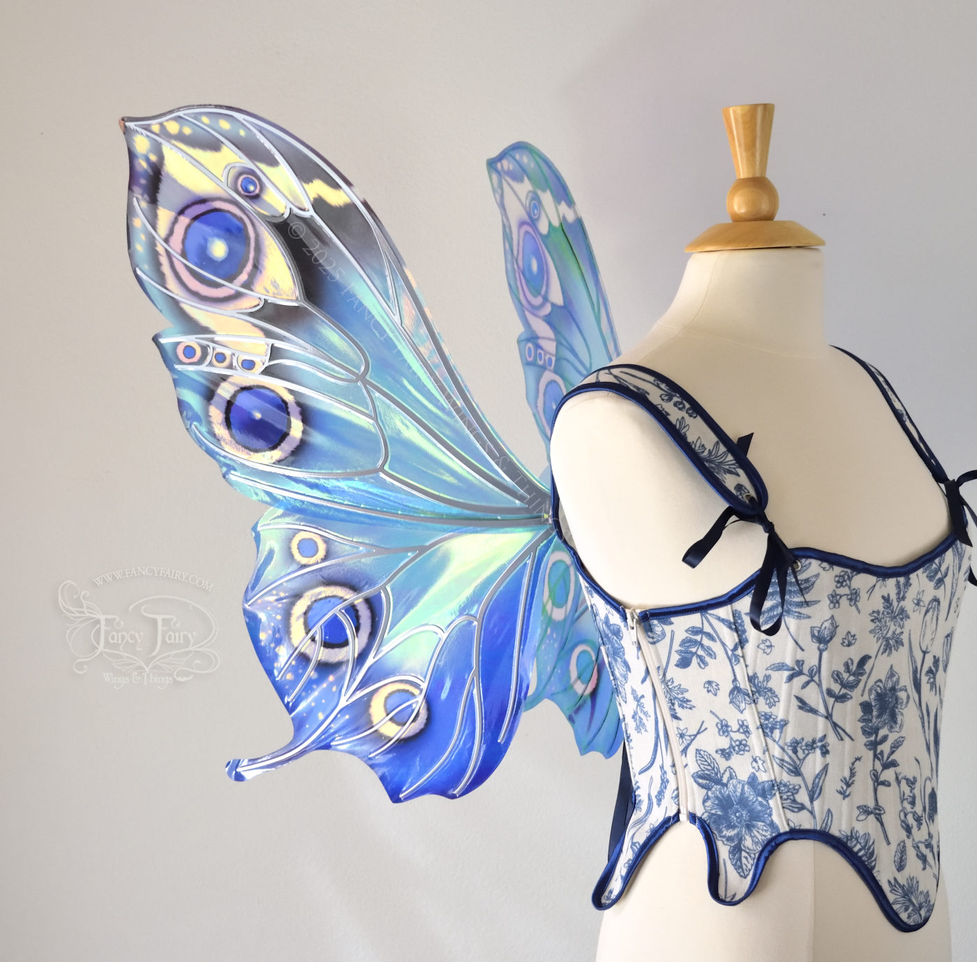 Blue iridescent butterfly shaped fairy wings with markings & 'eye' spots like the Buckeye butterfly, with silver veins, worn on a dress form, right side view