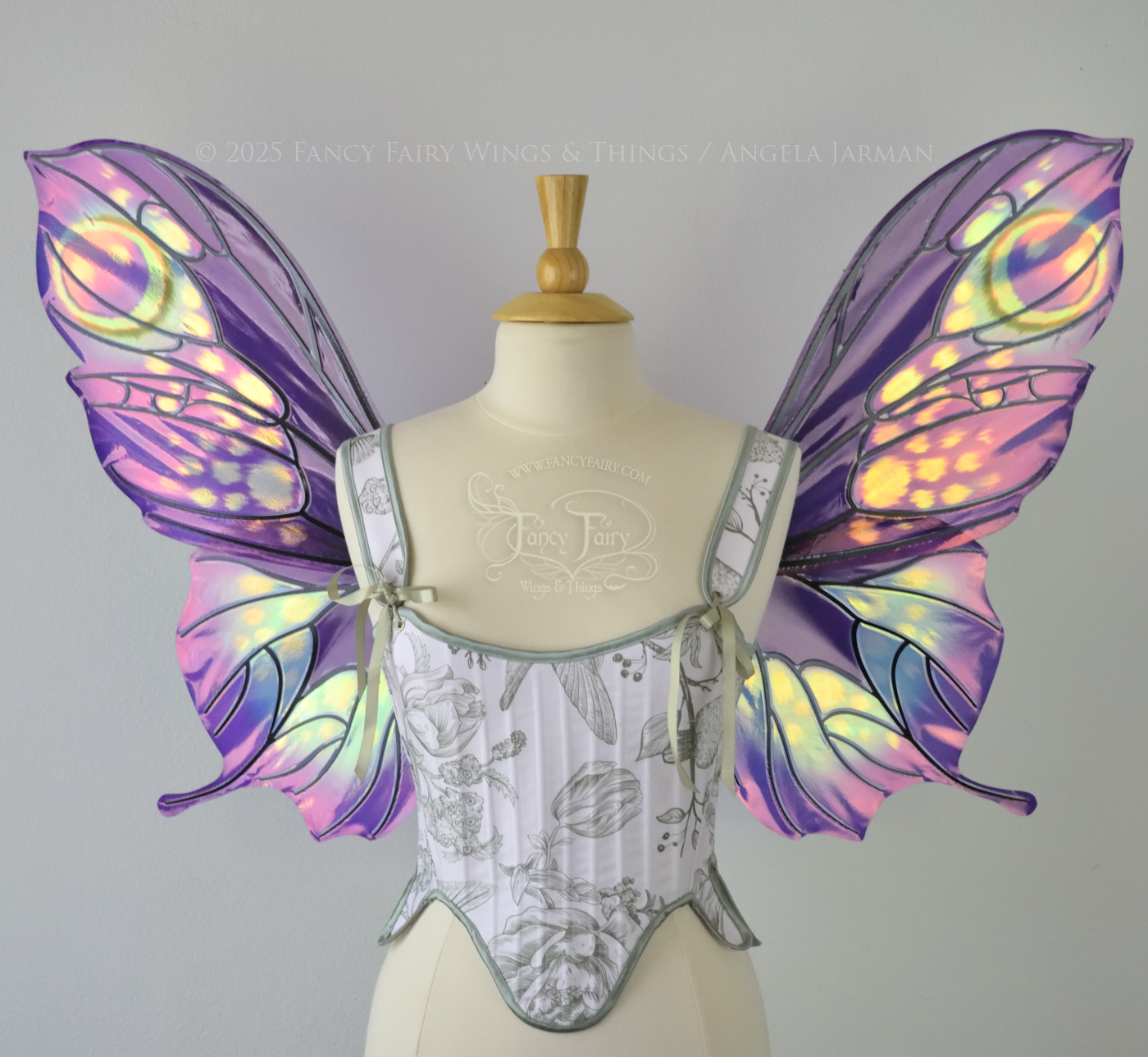 Iridescent fairy wings with a butterfly-like shape and short 'tails' in purples & blues with touches of pink & orange, front view