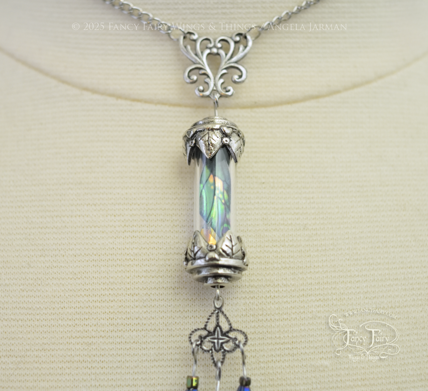 Closeup of silver necklace with vial containing fairy wings