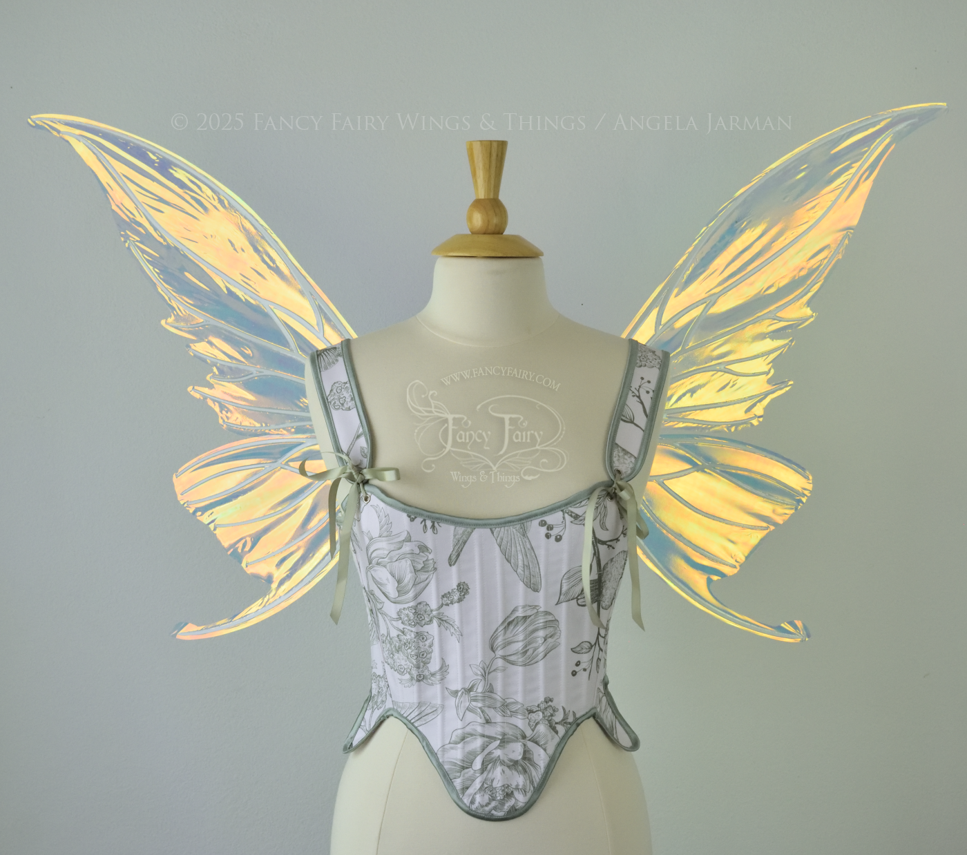 Iridescent transparent gold / orange / green fairy wings with small tails & white veins worn on a dress form, front view