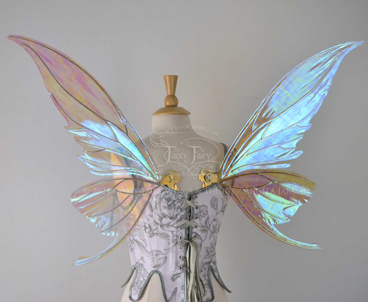 Large blue green iridescent fairy wings with gold veins worn with a white & sage green bodice on a dress form, back view