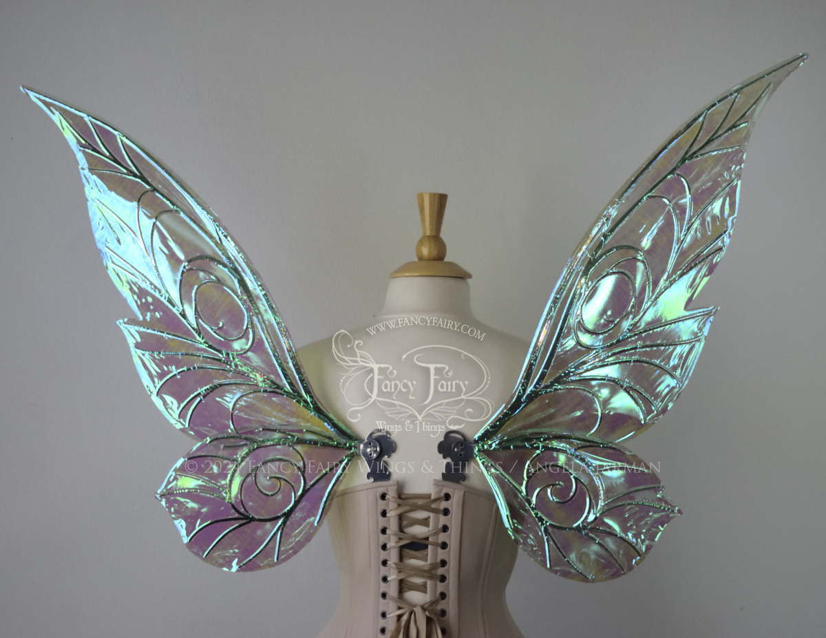 Back view of green iridescent Tinker Bell inspired fairy wings with swirly silver veins, displayed on a dress form