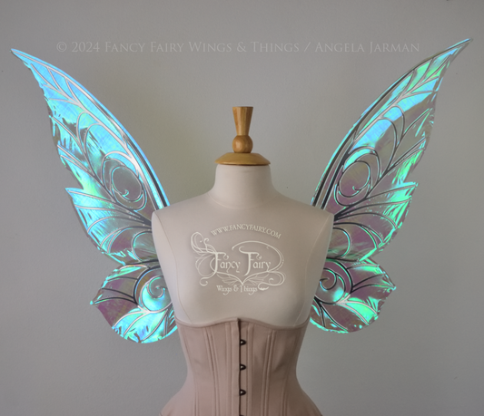 Front view of green iridescent Tinker Bell inspired fairy wings with swirly silver veins, displayed on a dress form