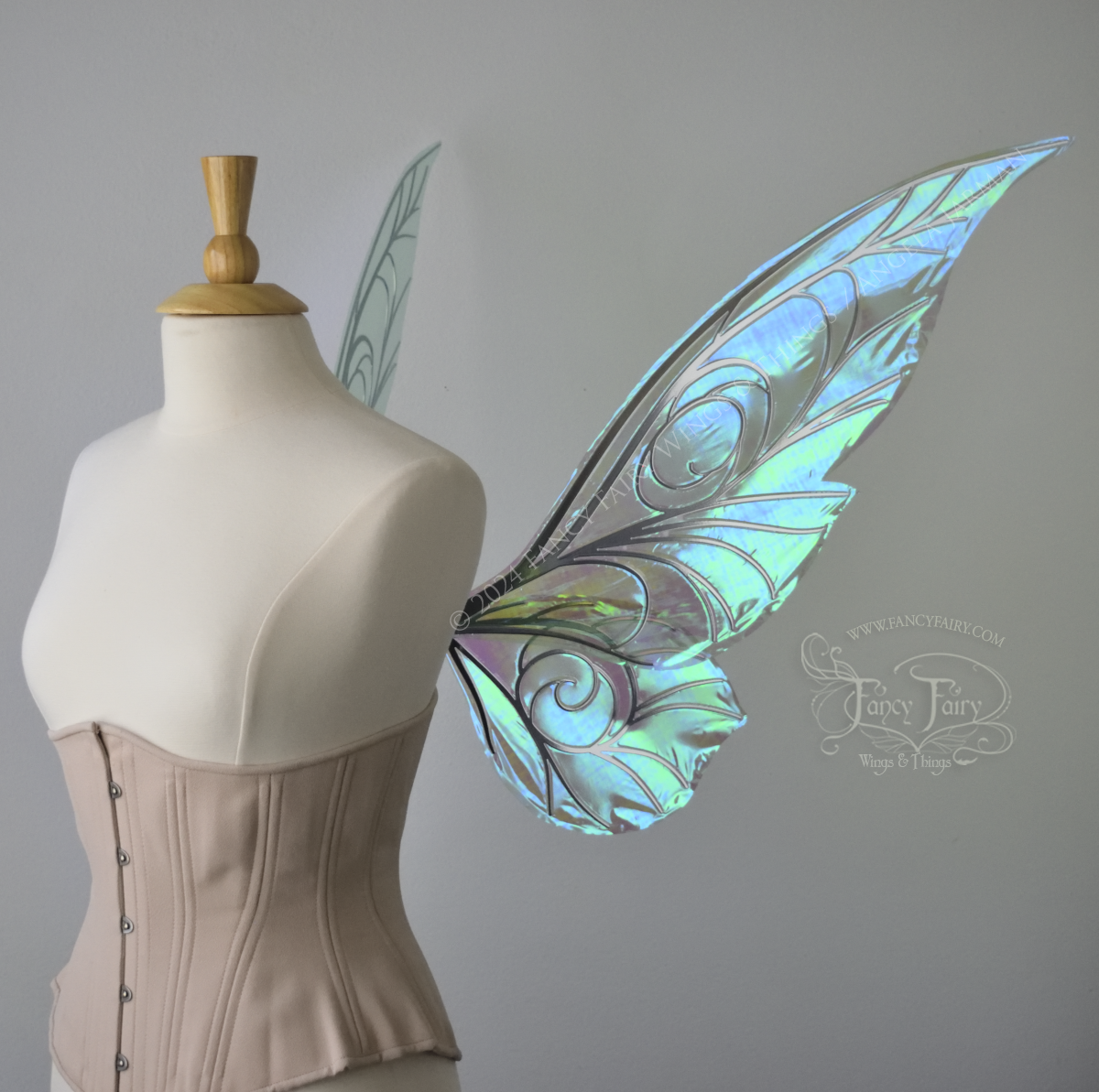 Right side view of green iridescent Tinker Bell inspired fairy wings with swirly silver veins, displayed on a dress form