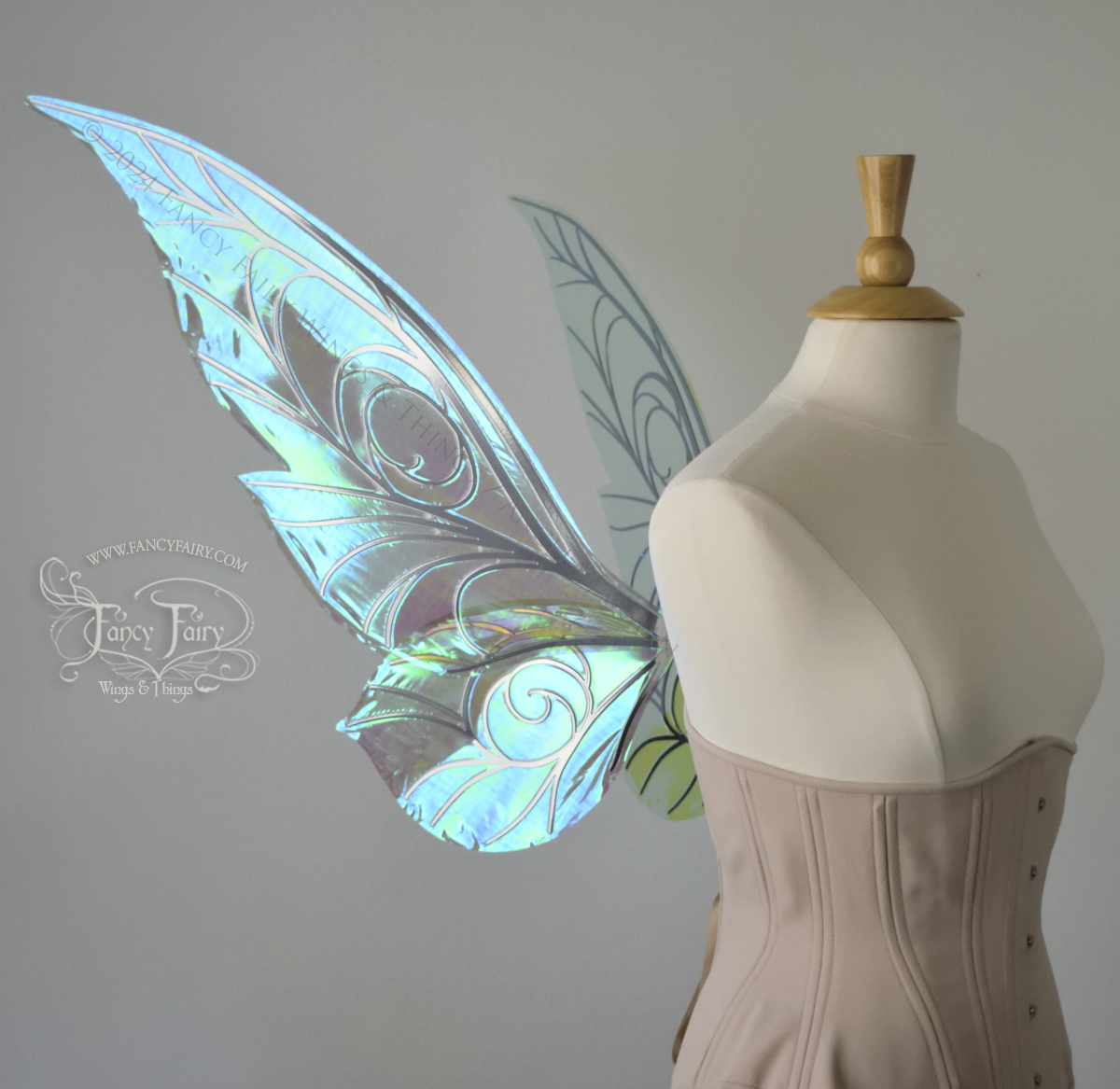 Left side view of green iridescent Tinker Bell inspired fairy wings with swirly silver veins, displayed on a dress form