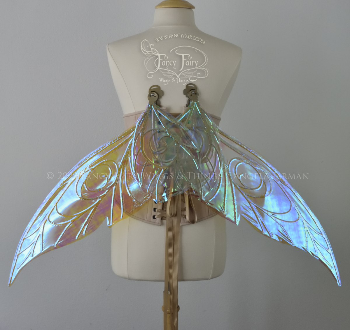 Back view, transparent blue iridescent Tinker Bell inspired fairy wings with swirly gold veins, displayed on dress form in resting position