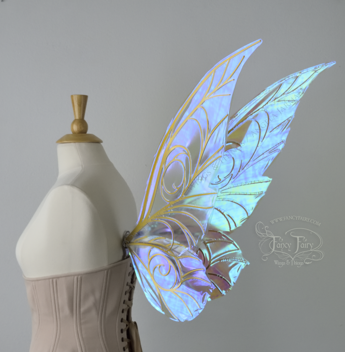 Back 3/4 view of transparent blue iridescent Tinker Bell inspired fairy wings with swirly gold veins, displayed on a dress form