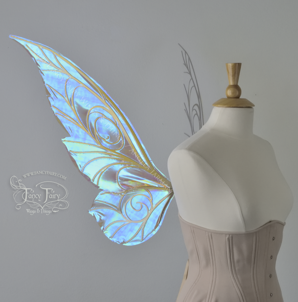 Left side view of transparent blue iridescent Tinker Bell inspired fairy wings with swirly gold veins, displayed on a dress form