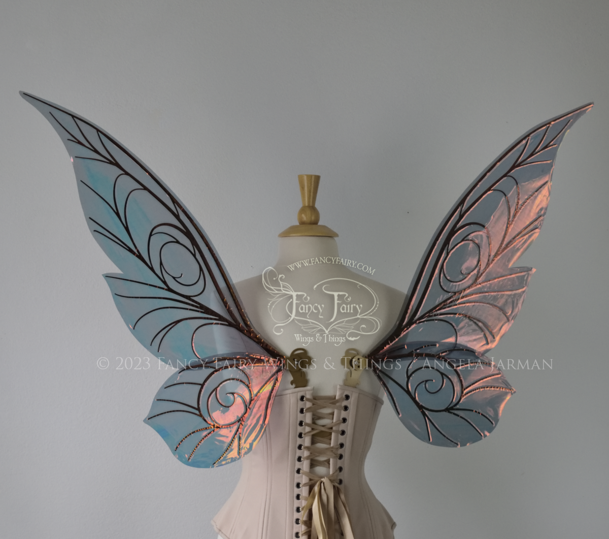 Back view of black / orange iridescent Tinker Bell inspired fairy wings with swirly gold veins, displayed on a dress form