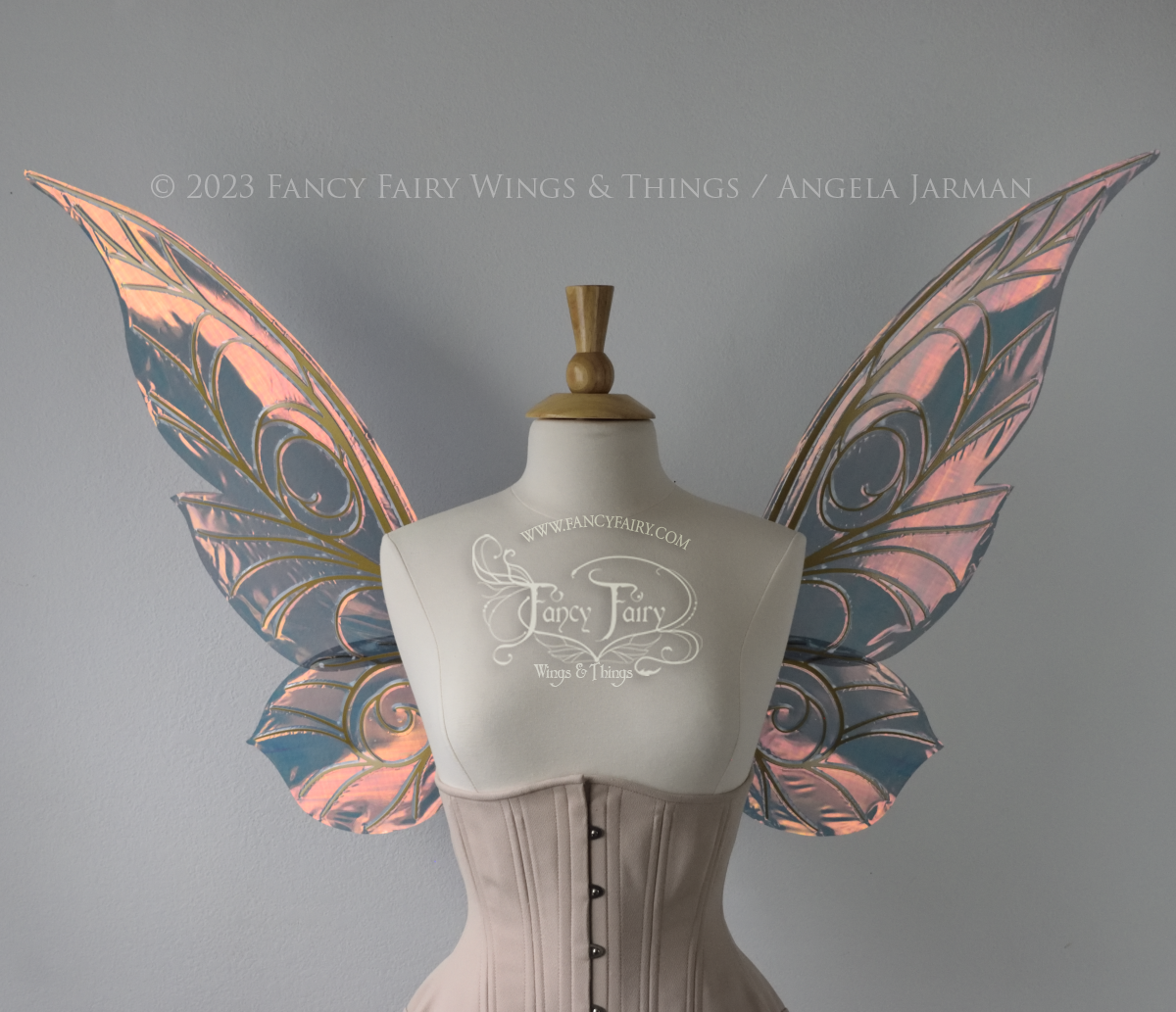 Front view of black / orange iridescent Tinker Bell inspired fairy wings with swirly gold veins, displayed on a dress form