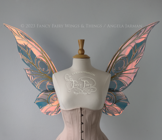 Front view of black / orange iridescent Tinker Bell inspired fairy wings with swirly gold veins, displayed on a dress form