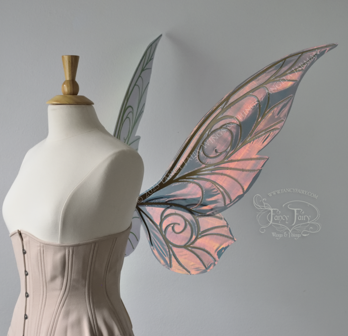 Right side view of black / orange iridescent Tinker Bell inspired fairy wings with swirly gold veins, displayed on a dress form