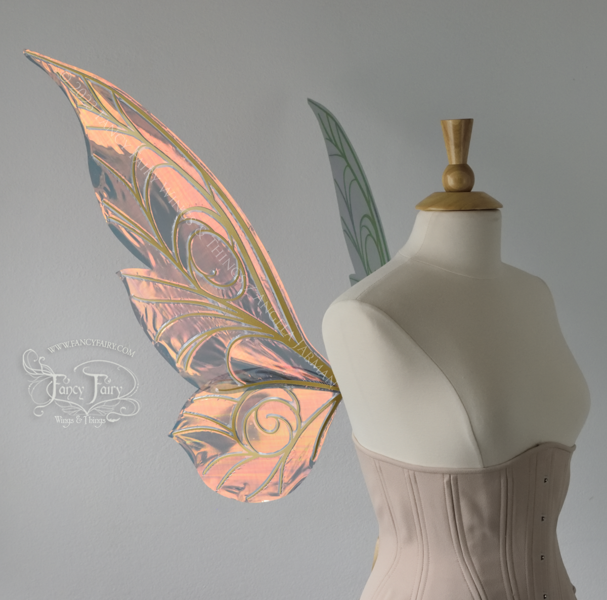 Left side view of black / orange iridescent Tinker Bell inspired fairy wings with swirly gold veins, displayed on a dress form