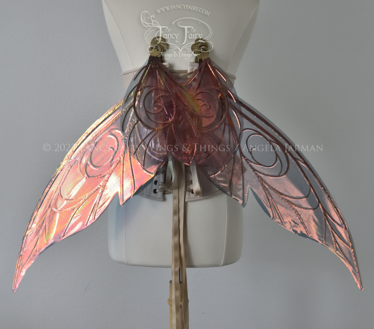 Back view of black / orange iridescent Tinker Bell inspired fairy wings with swirly gold veins, displayed on a dress form in resting position