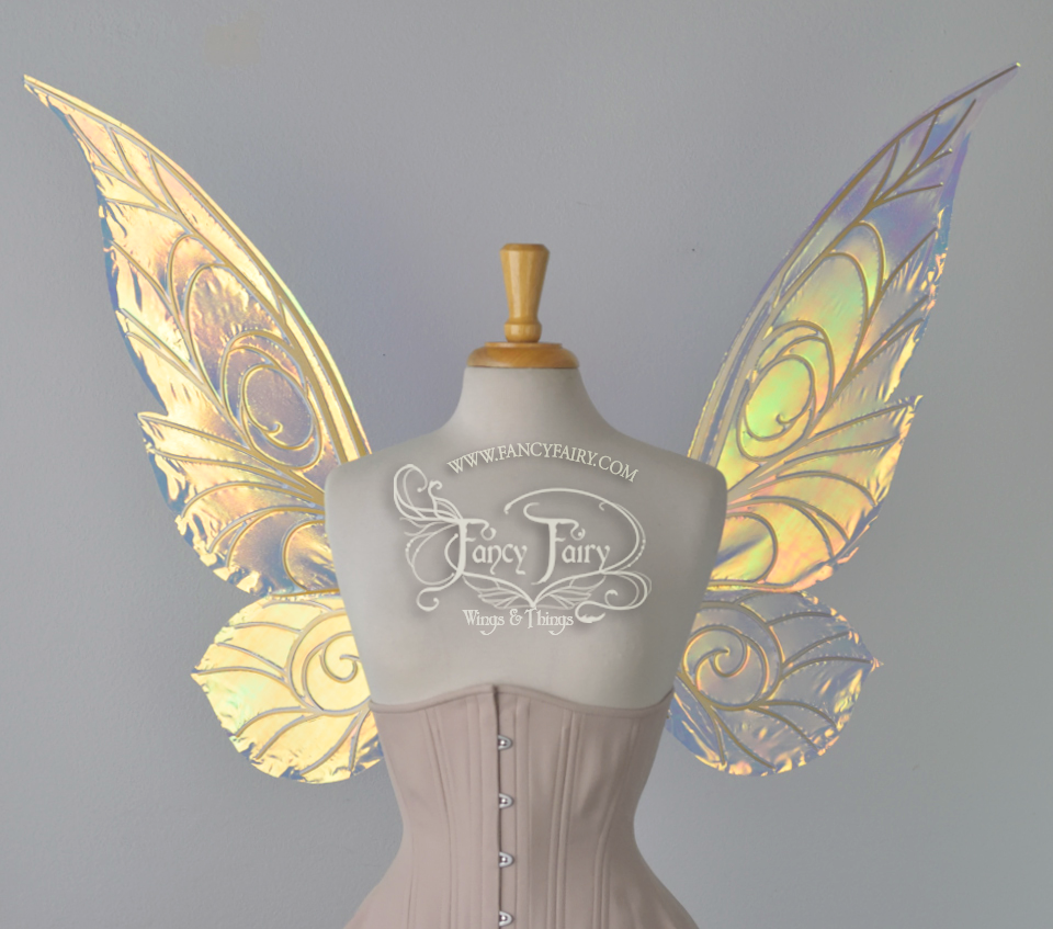 Front view of an ivory dress form wearing an alabaster underbust corset & large transparent iridescent fairy wings with spiraling whimsical gold veins & a classic pixie silhouette. Background is white, the Fancy Fairy Wings & Things logo is visible on the dress form's chest