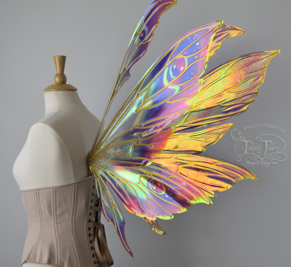 Extra large rainbow iridescent fairy wings with antennae and gold veins, back 3/4, worn on a dress form