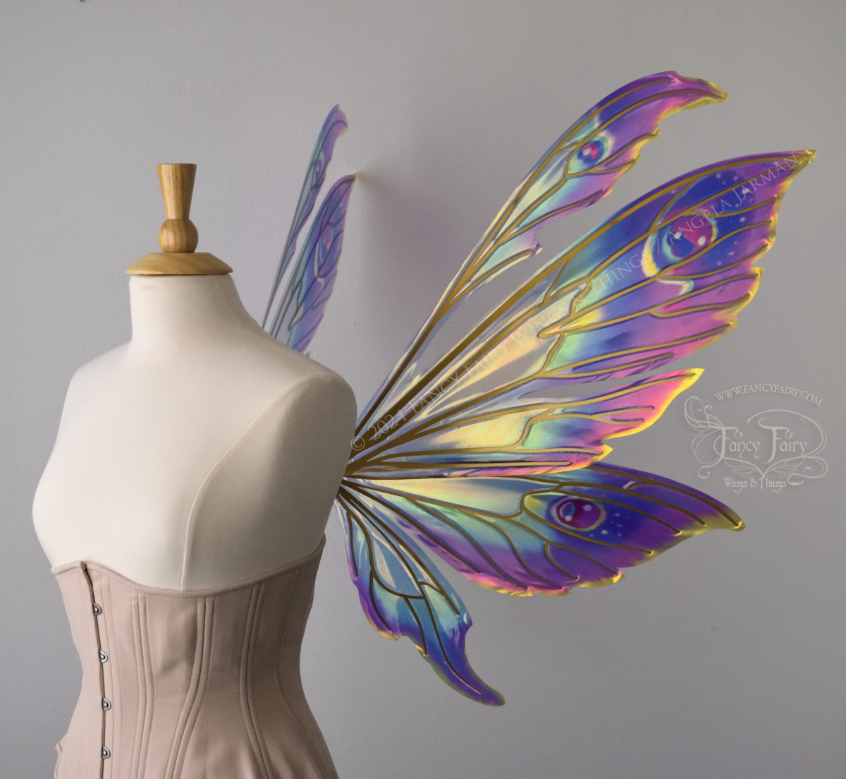 Extra large rainbow iridescent fairy wings with antennae and gold veins, worn on a dress form, right side view