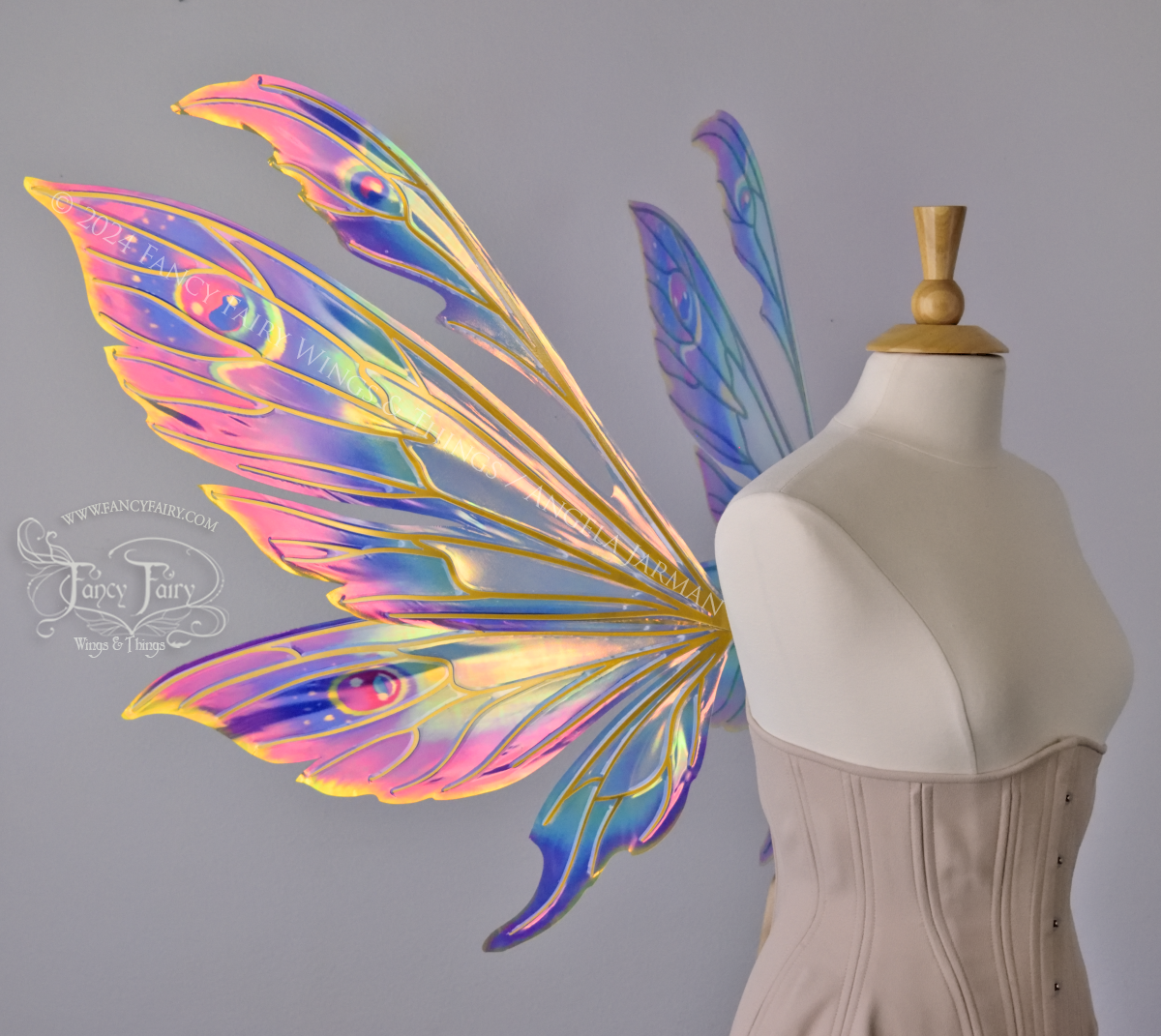 Extra large rainbow iridescent fairy wings with antennae and gold veins, worn on a dress form, left side view