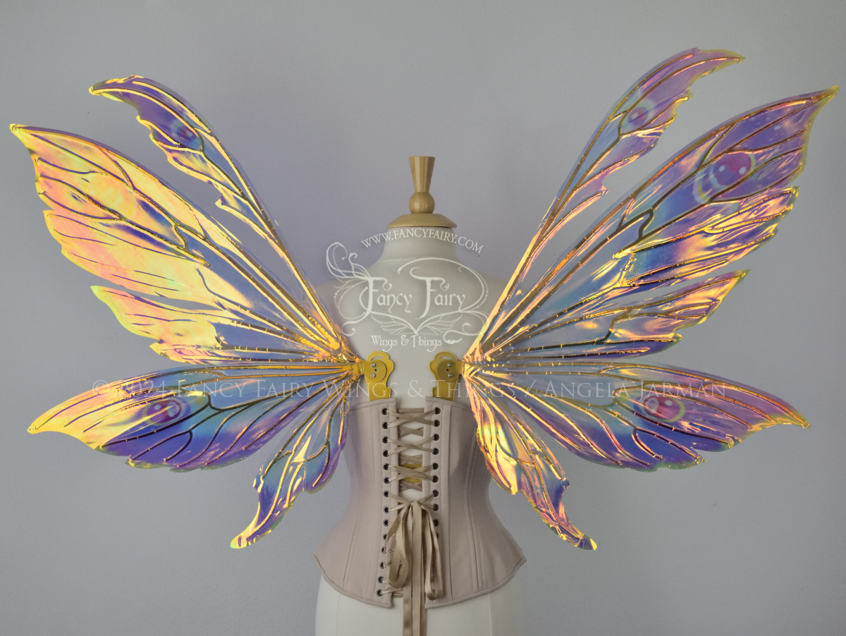 Extra large rainbow iridescent fairy wings with antennae and gold veins, worn on a dress form, Back view