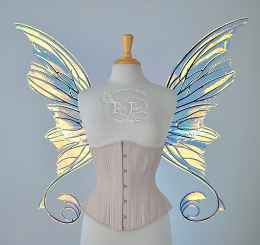 Front view of an ivory dress form wearing an alabaster underbust corset and large fairy wings with lots of intricate veins, some have 'thorns'. The upper panels curve slightly downwards along the top edge with pointy tips, the bottom panels have tails that curve inward toward the body. They are transparent and clear Diamond Fire iridescent, with black veins.