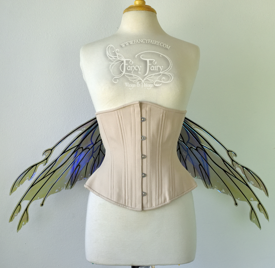 Front view of an ivory dress form wearing an alabaster underbust corset & purple / blue iridescent fairy wings with elongated upper panels with petal like appendages at the tips & antennae, the veins are black. Wings are lowered in resting position