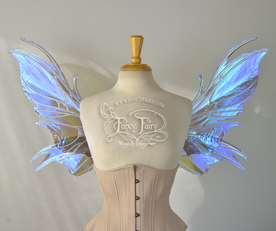 Front view of iridescent blue / purple fairy wings with spikey silver veins, worn by a dress form