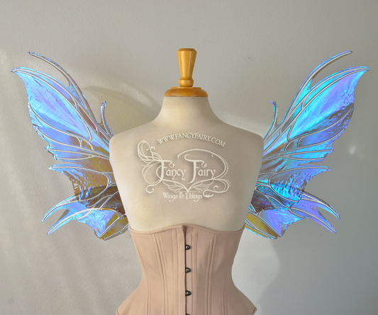 Front view of iridescent blue / purple fairy wings with spikey silver veins, worn by a dress form