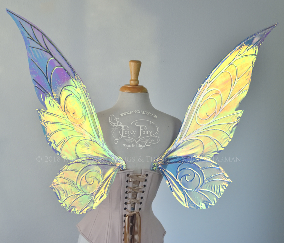 Back view of transparent green/yellow/orange iridescent Tinker Bell inspired fairy wings with swirly white veins, displayed on a dress form